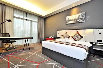 a hotel room with a large bed and a desk at The OAK SUITE AT Menara M101 KL in Kuala Lumpur