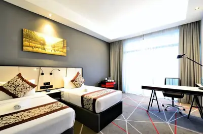 a hotel room with two beds and a piano at The OAK SUITE AT Menara M101 KL in Kuala Lumpur