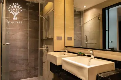 a bathroom with two sinks and a large mirror at The OAK SUITE AT Menara M101 KL in Kuala Lumpur