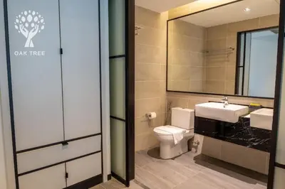 a bathroom with a toilet and a sink and a mirror at The OAK SUITE AT Menara M101 KL in Kuala Lumpur