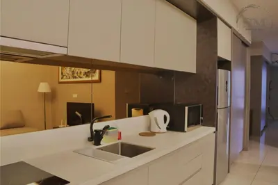 a kitchen with a sink and a microwave at Dorsett Residences Hartamas in Kuala Lumpur