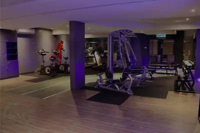 a gym with treadmills and exercise equipment in a building at Dorsett Residences Hartamas in Kuala Lumpur