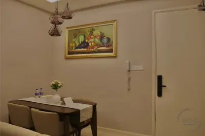 a dining room with a table and a picture on the wall at Dorsett Residences Hartamas in Kuala Lumpur