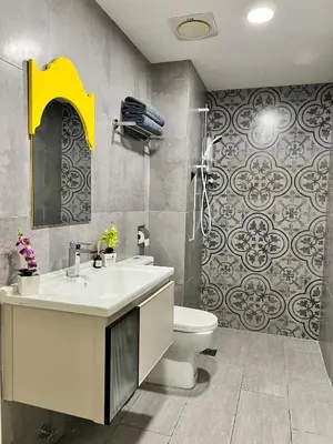 a bathroom with a sink and a toilet at Arte Mont Kiara By ANQ Suites in Kuala Lumpur