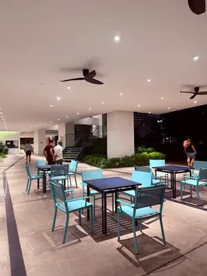 a group of tables and chairs in a building at TRX Continew Residence by Nia in Kuala Lumpur