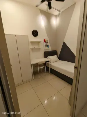 a small room with a bed and a desk at TRX Continew Residence by Nia in Kuala Lumpur
