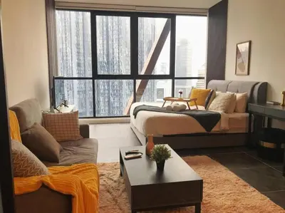 a living room with a couch and a large window at Klcc Suites at Twin Tower in Kuala Lumpur
