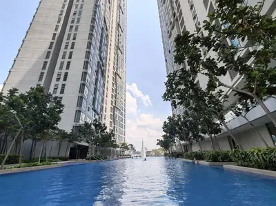 a swimming pool in the middle of two tall buildings at Robertson to be opened in Kuala Lumpur