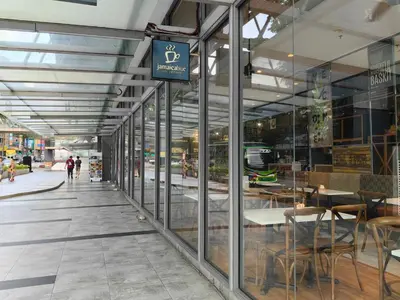 a store front with tables and chairs in a building at Robertson to be opened in Kuala Lumpur