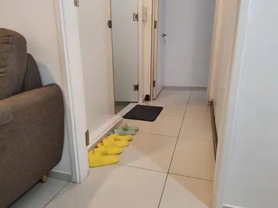 a hallway with yellow rubber shoes on the floor at Robertson to be opened in Kuala Lumpur