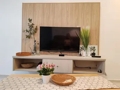 a flat screen tv sitting on top of a entertainment center at The Robertson R9 Walk to Jalan Alor Street Bukit Bintang Pavilion 7 pax 2R1B in Kuala Lumpur