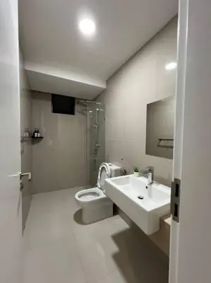 a bathroom with a sink and a toilet at The City Edge United Point in Kuala Lumpur