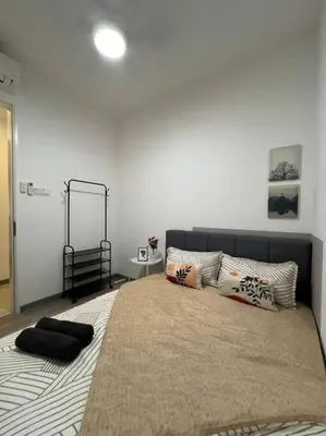 a bedroom with a large bed with pillows on it at The City Edge United Point in Kuala Lumpur