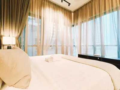 a bedroom with a white bed and a window at 7 Kuala Lumpur City for 4 to 12 PAX of 4 BEDROOMS and 3 BATHROOMS near KLCC in Kuala Lumpur