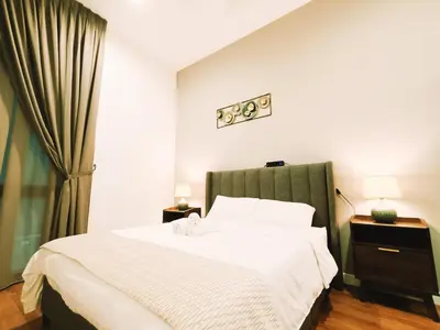 a bedroom with a large bed with a green headboard at 7 Kuala Lumpur City for 4 to 12 PAX of 4 BEDROOMS and 3 BATHROOMS near KLCC in Kuala Lumpur