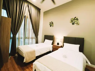 two beds in a room with a window at 7 Kuala Lumpur City for 4 to 12 PAX of 4 BEDROOMS and 3 BATHROOMS near KLCC in Kuala Lumpur