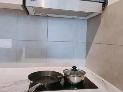 a pot on top of a stove in a kitchen at Luxury 4 Bedroom Suite at Cheras Maluri MRT in Kuala Lumpur