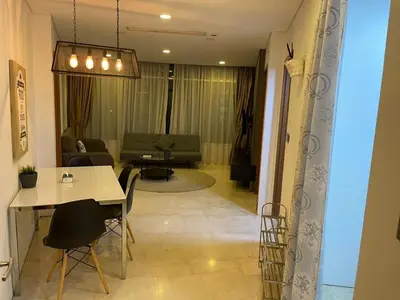 a living room with a table and chairs and a couch at Vortex Family suites Apartment in Kuala Lumpur