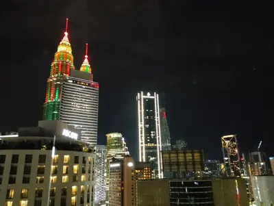 a city skyline at night with lit up buildings at Vortex Family suites Apartment in Kuala Lumpur