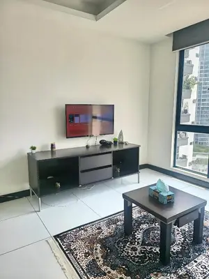 a living room with a tv and a coffee table at Casa Residency Apartments and suites KL in Kuala Lumpur