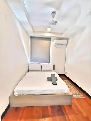 a small bedroom with a bed with a hat on it at Casa Residency Apartments and suites KL in Kuala Lumpur