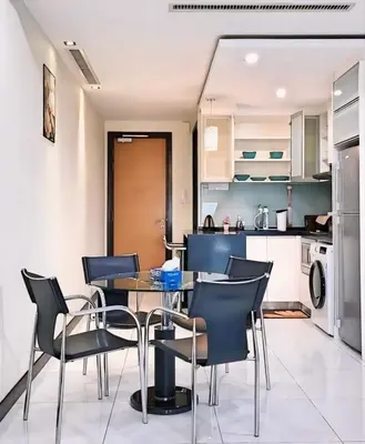 a kitchen and dining room with a table and chairs at Casa Residency Apartments and suites KL in Kuala Lumpur