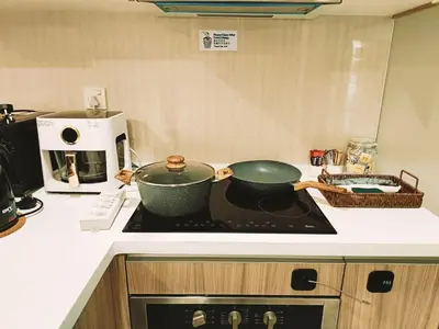 a kitchen with two pots on top of a stove at 8 Kuala Lumpur City for 4 to 10 PAX of 4 BEDROOMS and 3 BATHROOMS near KLCC in Kuala Lumpur