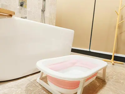 a white chair sitting next to a bath tub at 8 Kuala Lumpur City for 4 to 10 PAX of 4 BEDROOMS and 3 BATHROOMS near KLCC in Kuala Lumpur