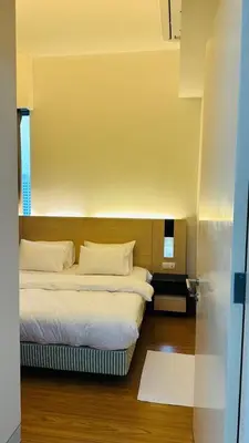 a bedroom with a bed with white sheets and pillows at SG Residence Kuala Lumpur by Fortune Suites in Kuala Lumpur