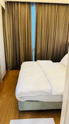 a large bed in a room with curtains at SG Residence Kuala Lumpur by Fortune Suites in Kuala Lumpur