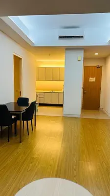 a room with a table and chairs and a kitchen at SG Residence Kuala Lumpur by Fortune Suites in Kuala Lumpur