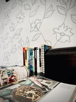 a shelf with books and a magazine on a table at Damas Hotel,Suites and Residence at Plaza Damas 3 by Over The Moon in Kuala Lumpur