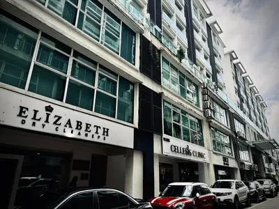 a building with cars parked in front of it at Damas Hotel,Suites and Residence at Plaza Damas 3 by Over The Moon in Kuala Lumpur