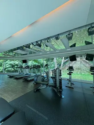 a gym with rows of treadmills and elliptical machines at Damas Hotel,Suites and Residence at Plaza Damas 3 by Over The Moon in Kuala Lumpur