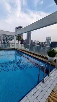 a swimming pool on the roof of a building at KLCC Apartment in Kuala Lumpur