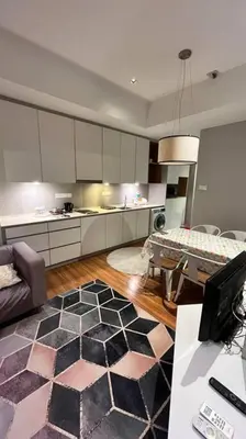 a kitchen with a living room with a couch and a table at KLCC Apartment in Kuala Lumpur