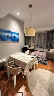 a living room with a table and a couch at KLCC Apartment in Kuala Lumpur