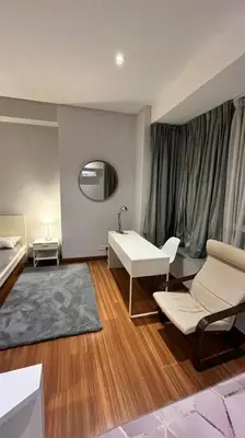 a living room with a desk and a chair and a table at KLCC Apartment in Kuala Lumpur