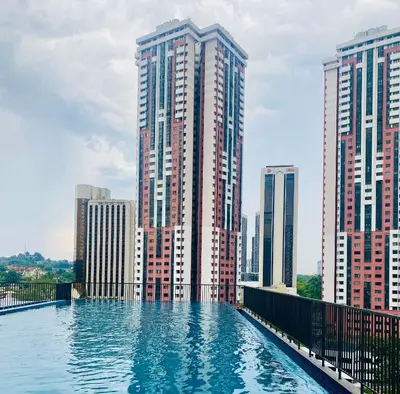 a pool of water in front of tall buildings at Chambers Luxury Suites By Zaff in Kuala Lumpur