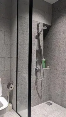 a shower in a bathroom with a glass door at Scarletz Suites KLCC by Luxe Suites in Kuala Lumpur