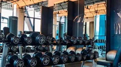 a rack of dumbbells in a gym at Scarletz Suites KLCC by Luxe Suites in Kuala Lumpur