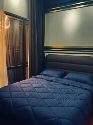 a bedroom with a bed with a blue blanket at Blue cozy duplex house in Kuala Lumpur