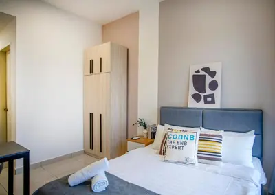 a bedroom with a bed with a sign on it at Trion Residence KL near TRX, MyTown, Ikea Cheras, Pudu in Kuala Lumpur