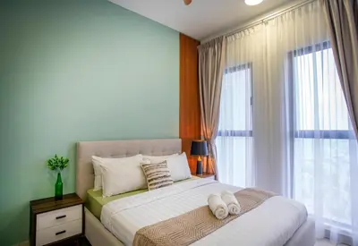 a bedroom with a bed with two white shoes on it at Trion Residence KL near TRX, MyTown, Ikea Cheras, Pudu in Kuala Lumpur