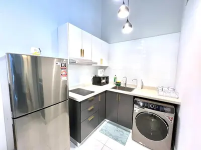 a kitchen with a stainless steel refrigerator and a dishwasher at Arte Cheras Kuala Lumpur in Kuala Lumpur