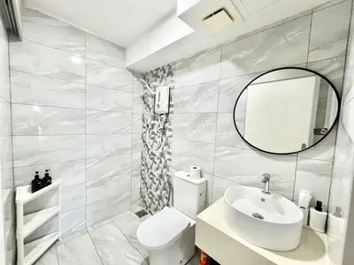 a bathroom with a white toilet and a mirror at Arte Cheras Kuala Lumpur in Kuala Lumpur