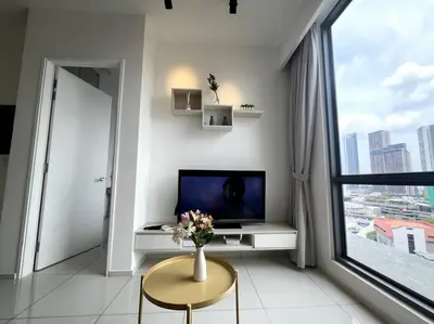 a living room with a television and a vase of flowers on a table at The Robertson KLCC 1 room 1 bathroom by JZ in Kuala Lumpur