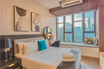 a bedroom with a large bed and a large window at Staybliss At Ceylonz Suites in Kuala Lumpur