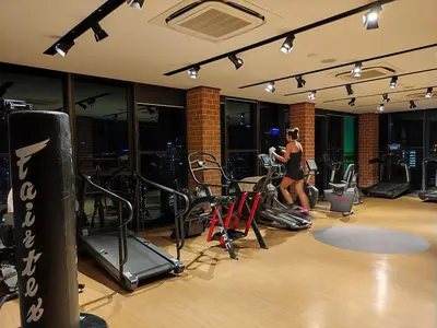 a woman in a gym with some exercise equipment at Staybliss At Ceylonz Suites in Kuala Lumpur