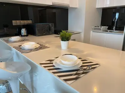 a kitchen counter with plates and utensils on it at Star Residence By M&T in Kuala Lumpur